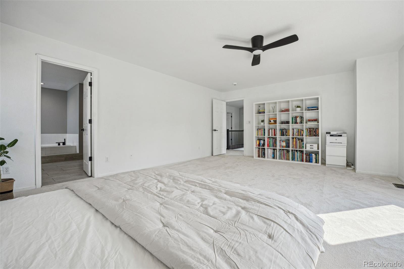 1711 Spring Water Lane Highlands Ranch, CO 80129 - Photo 25 of 48 a bedroom with a large bed closet and a window