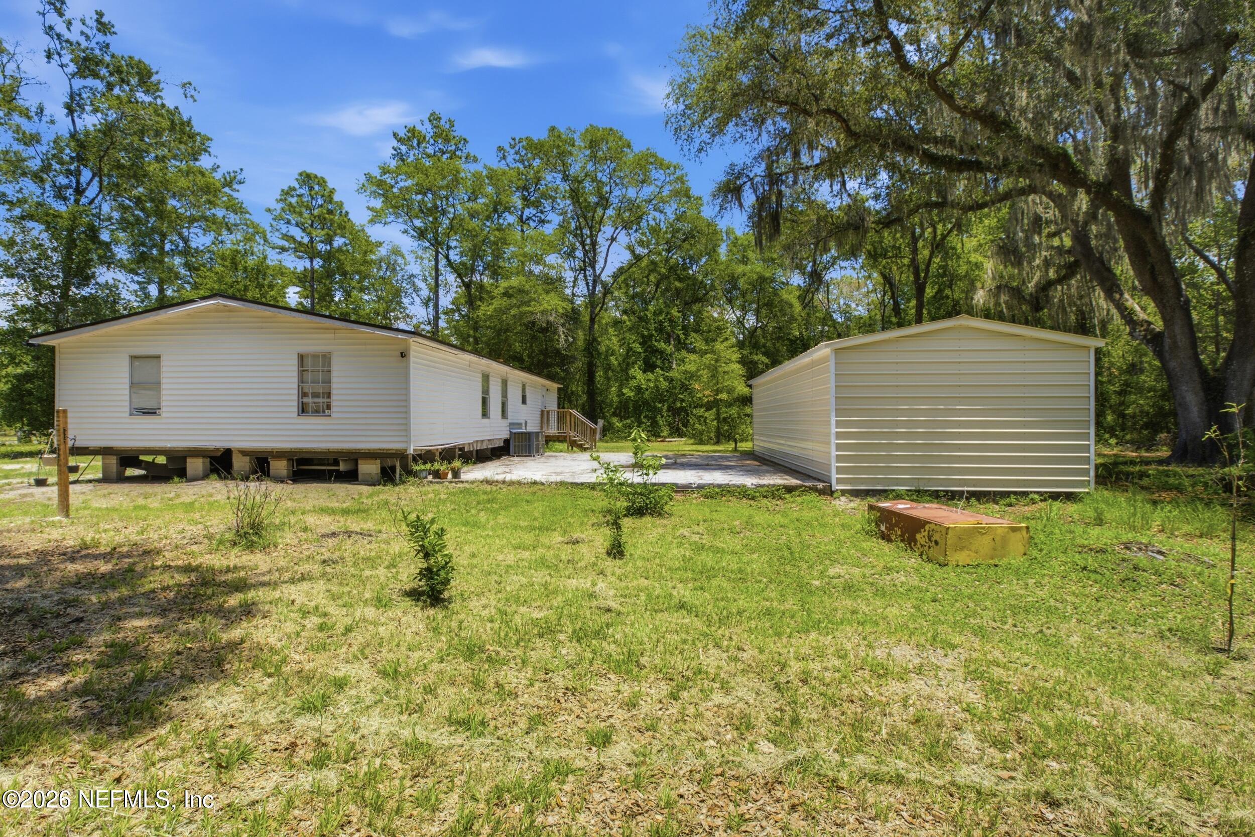 5667 Long Branch Cemetery Road Jacksonville, FL 32234 - Photo 2 of 24 a view of a backyard with swimming pool