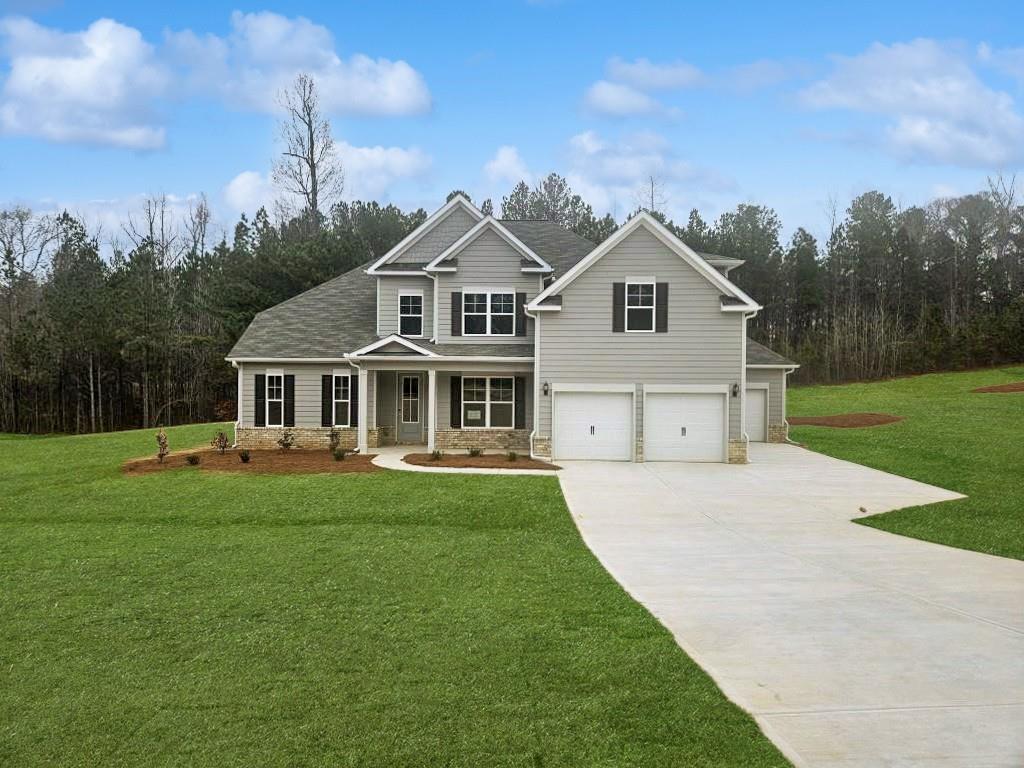 a front view of a house with a garden