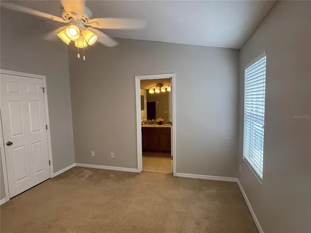 a bathroom with a granite countertop sink a mirror and shower