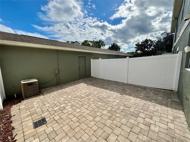 a backyard of a house with table and chairs