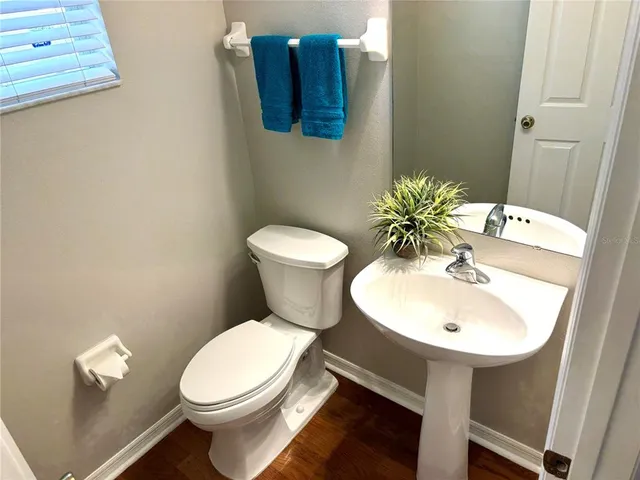 a white toilet sitting next to a bathroom sink
