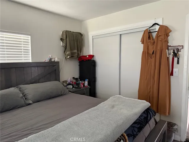 a bedroom with a bed and a mirror