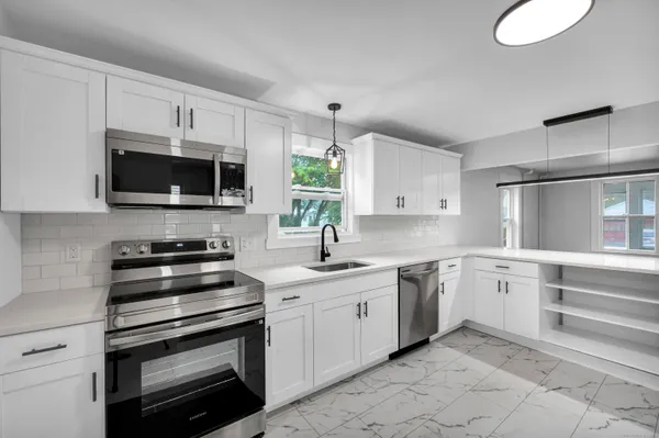 a kitchen with a sink stove and microwave