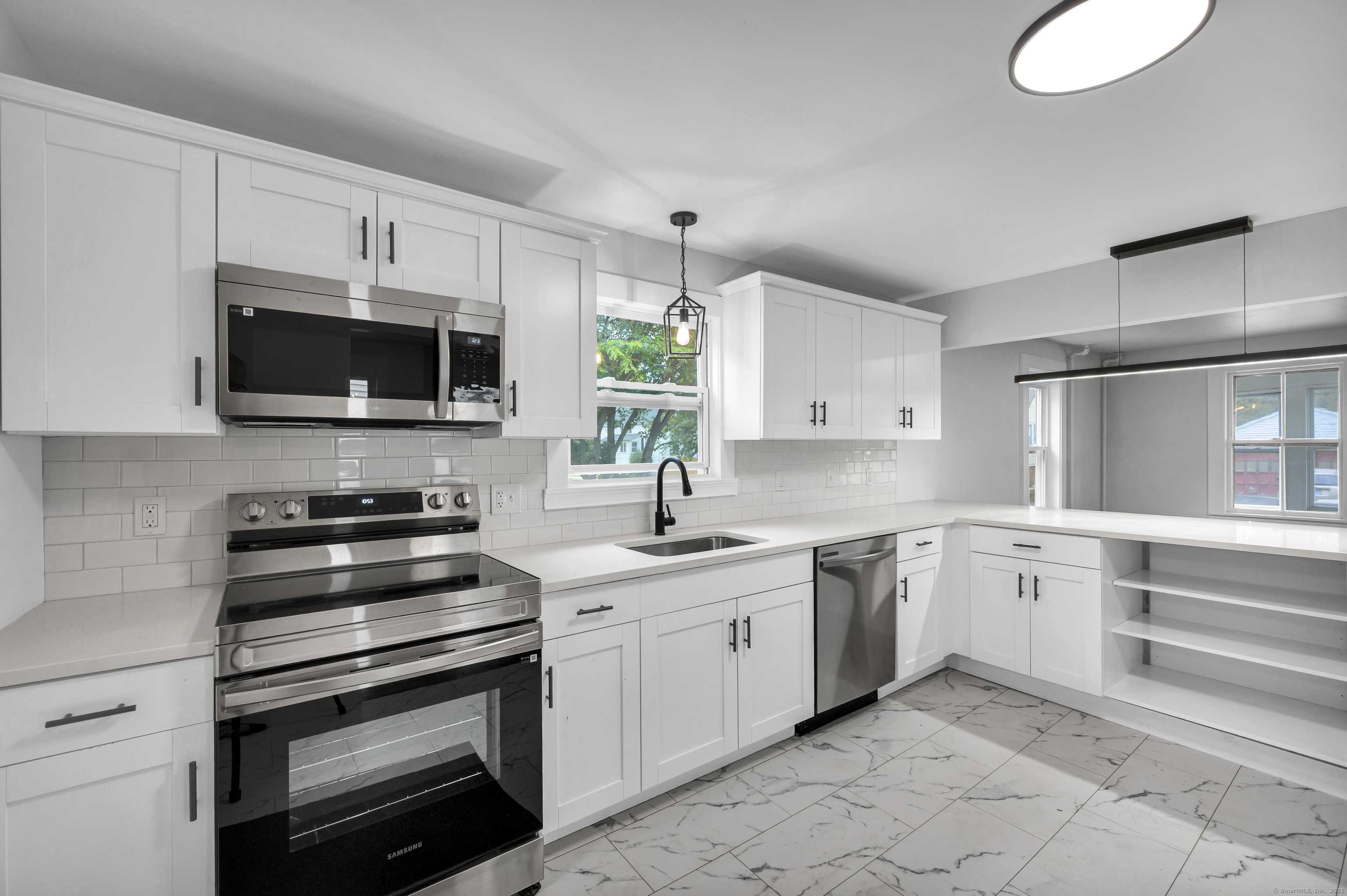 a kitchen with a sink stove and microwave