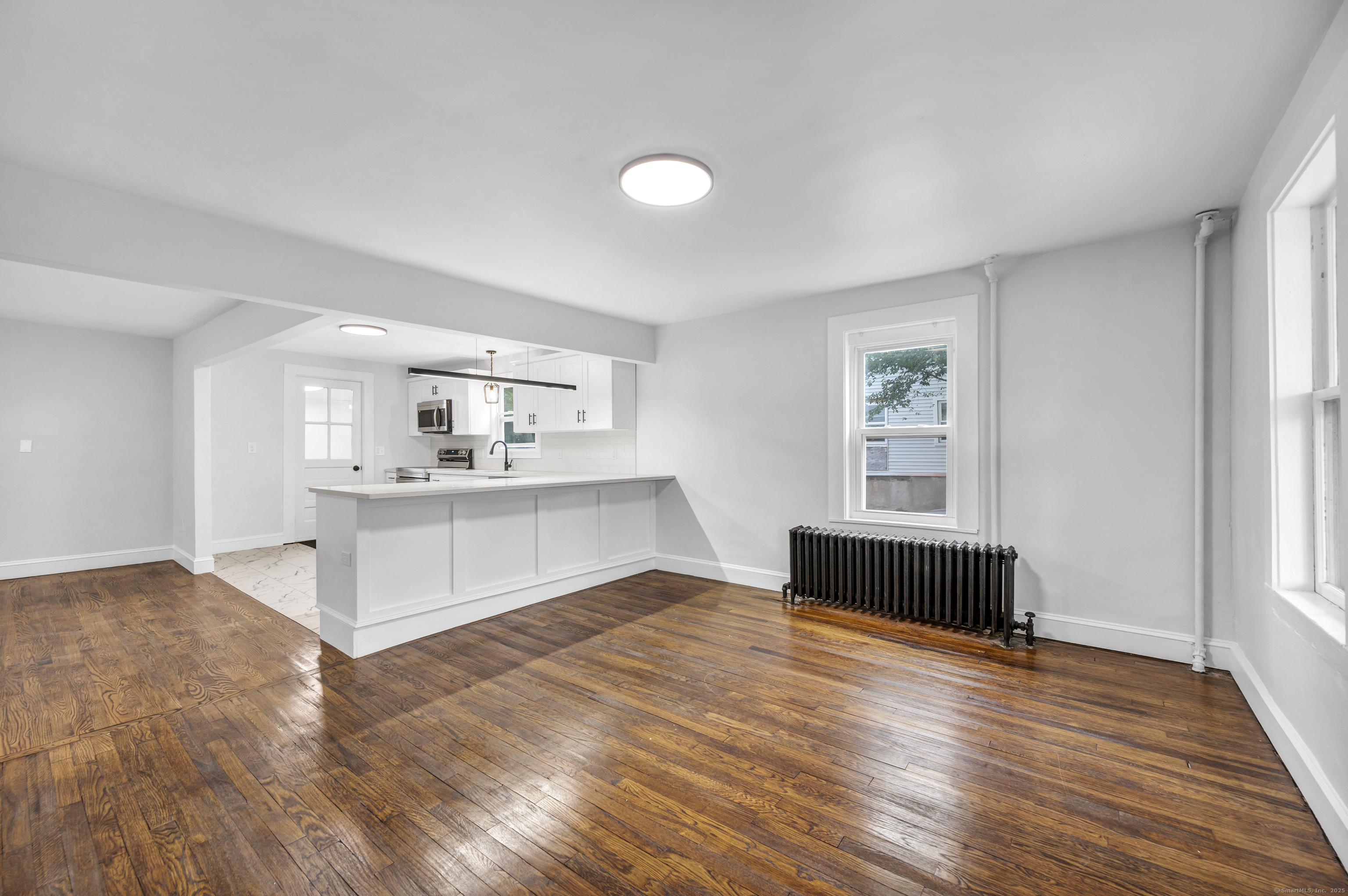 291 Main Street Cromwell, CT 06416 - Photo 12 of 38 a view of a kitchen with wooden floor and a window