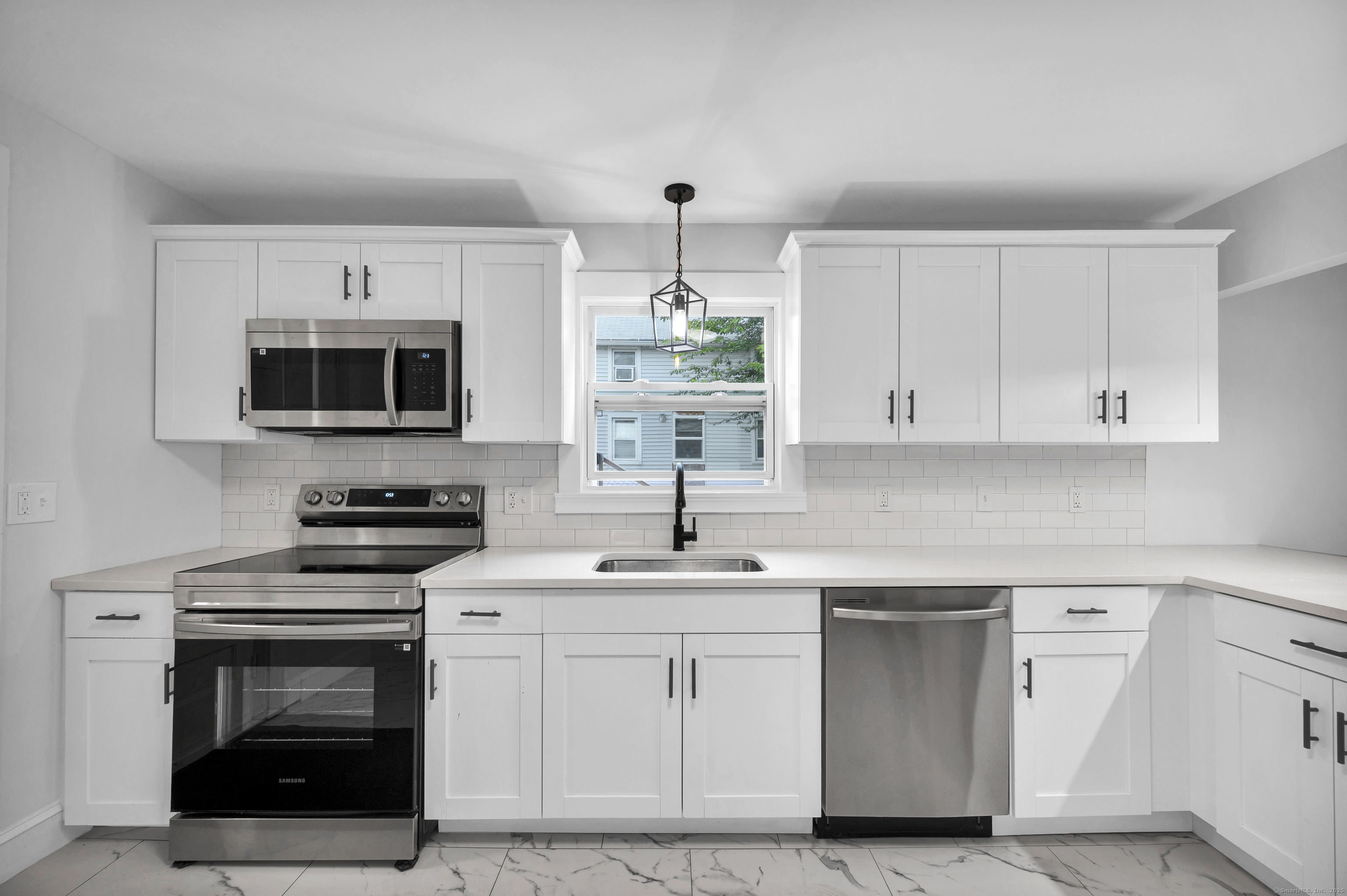 291 Main Street Cromwell, CT 06416 - Photo 15 of 38 a kitchen with a sink stove and microwave
