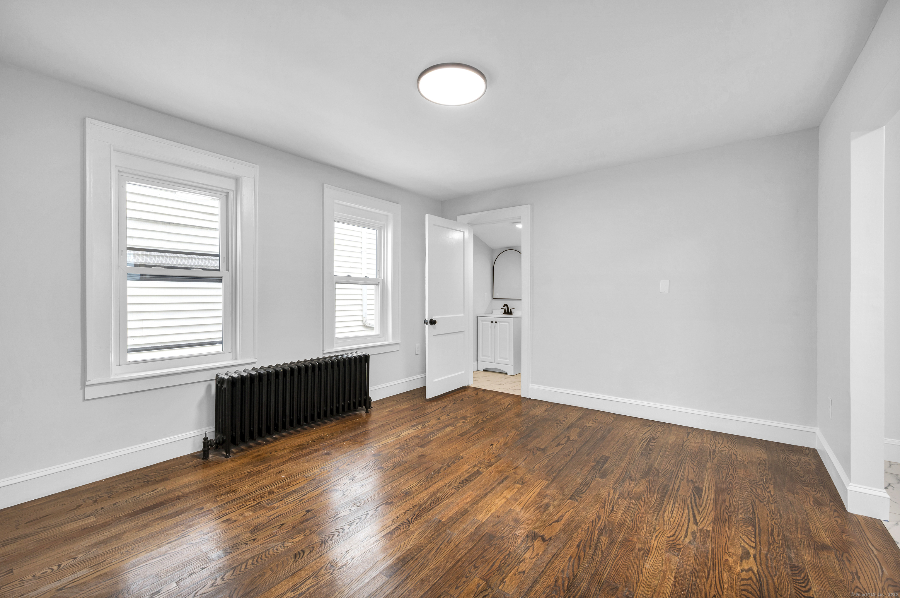 291 Main Street Cromwell, CT 06416 - Photo 18 of 38 an empty room with wooden floor and windows