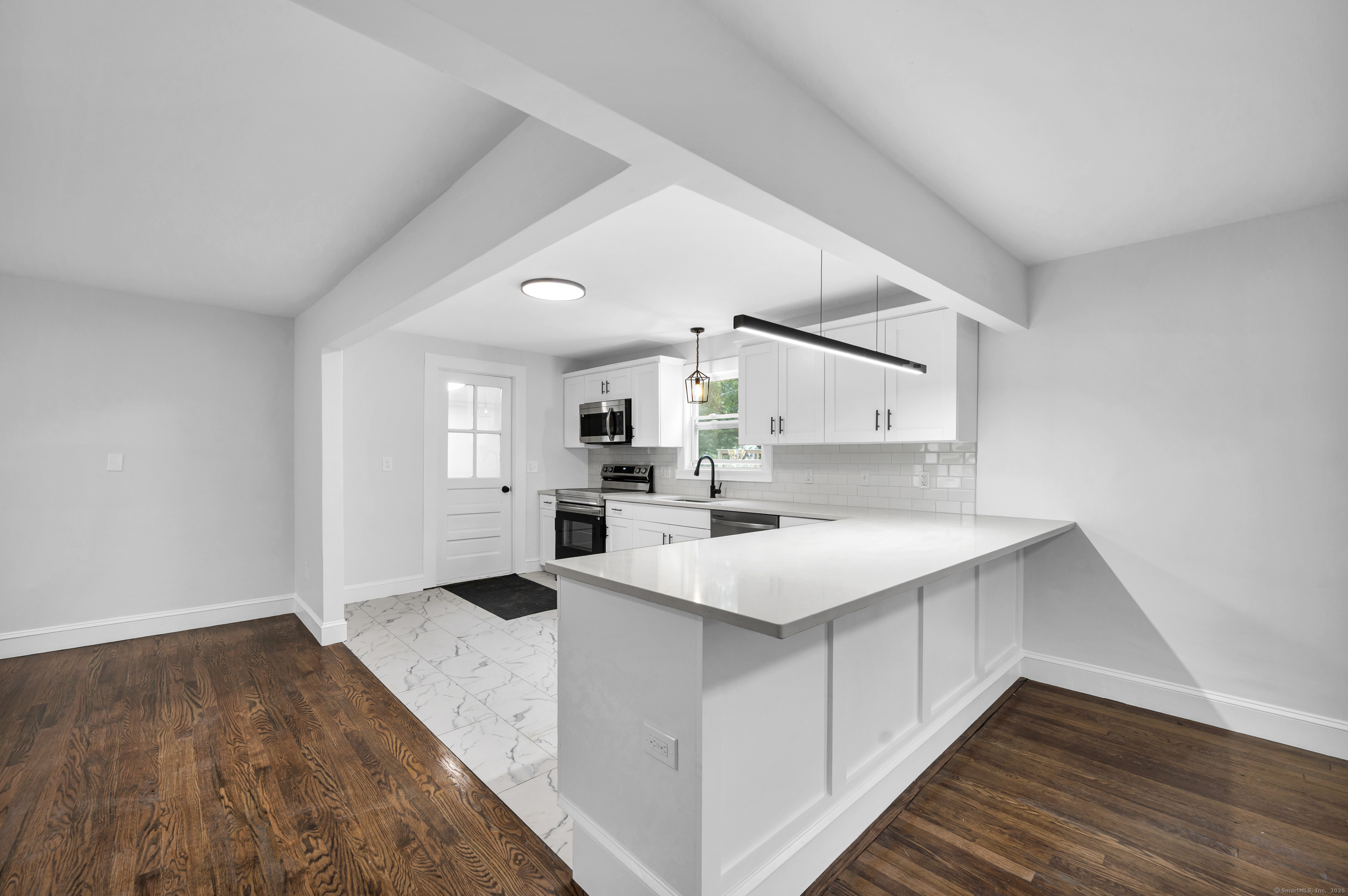 291 Main Street Cromwell, CT 06416 - Photo 2 of 38 a kitchen with a sink cabinets and wooden floor