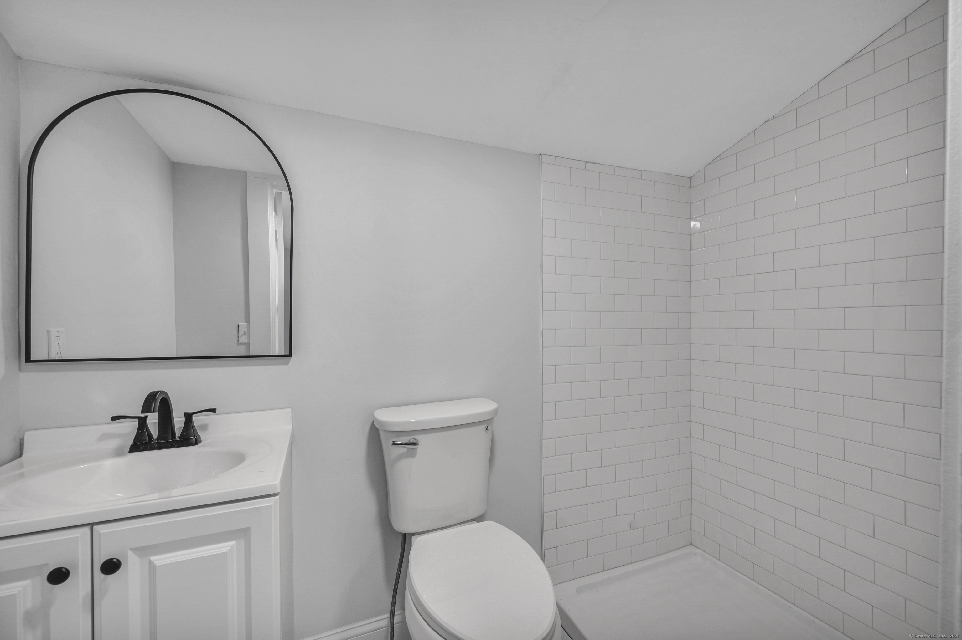 291 Main Street Cromwell, CT 06416 - Photo 21 of 38 a bathroom with a toilet sink vanity and mirror