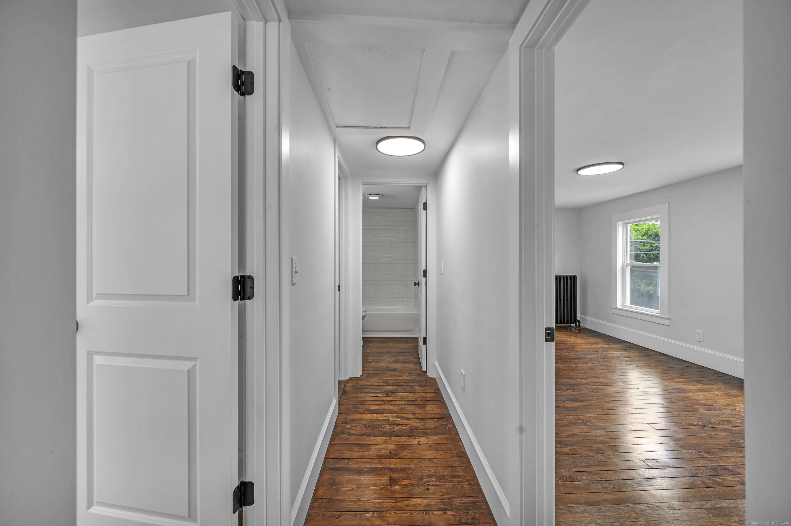 291 Main Street Cromwell, CT 06416 - Photo 26 of 38 a view of a hallway with wooden floor windows and stairs