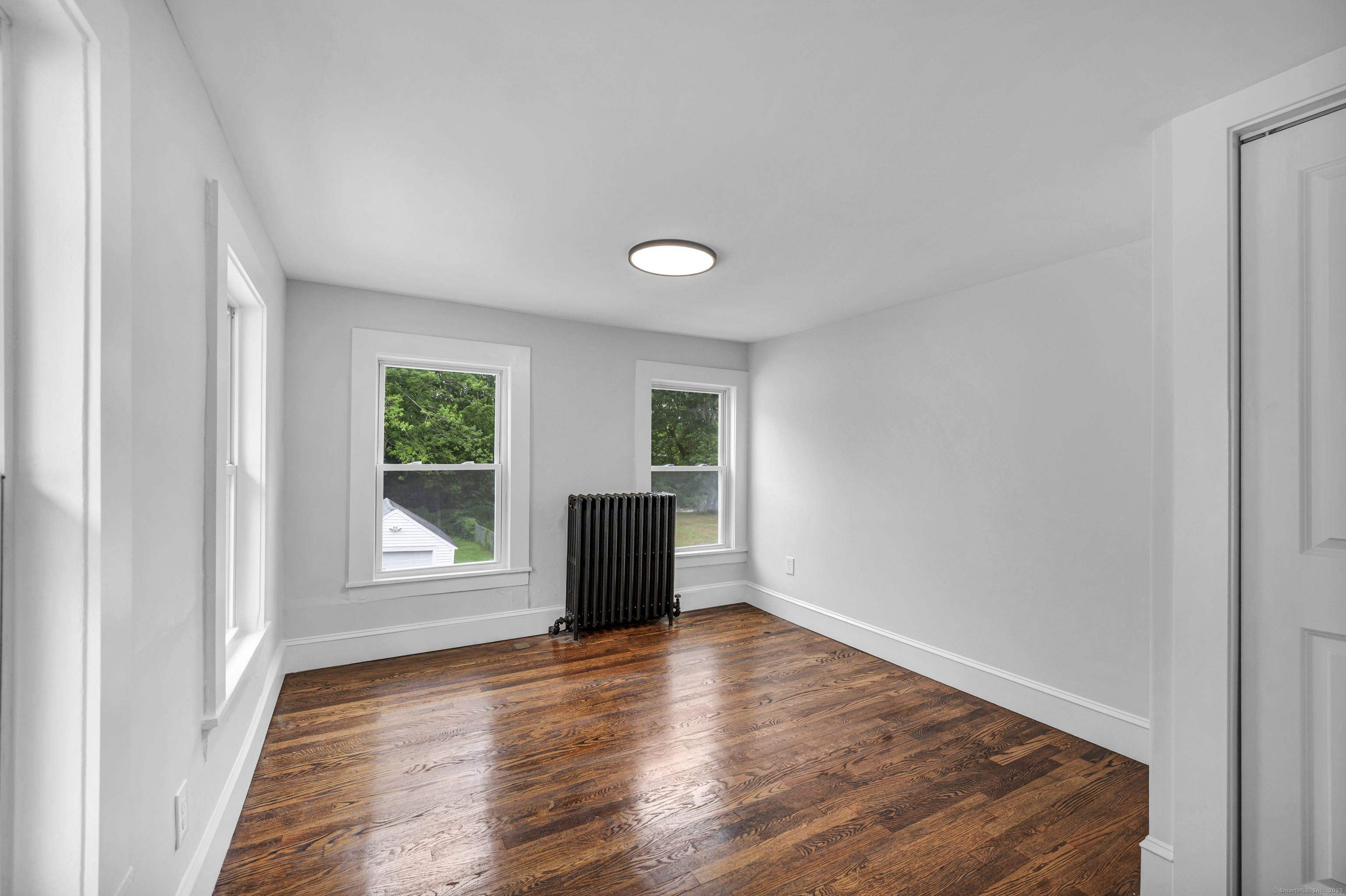 291 Main Street Cromwell, CT 06416 - Photo 27 of 38 an empty room with wooden floor and windows