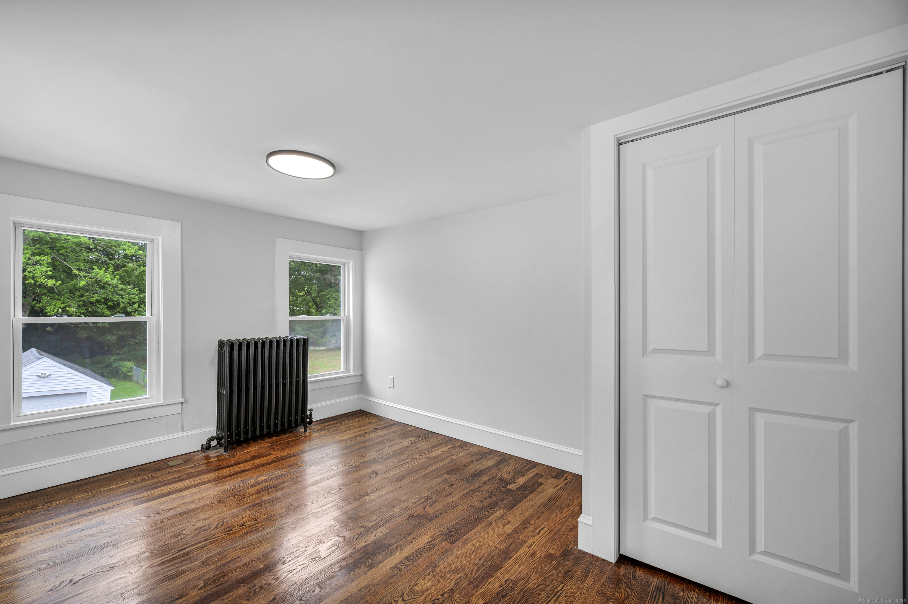 291 Main Street Cromwell, CT 06416 - Photo 28 of 38 a view of an empty room with wooden floor and a window