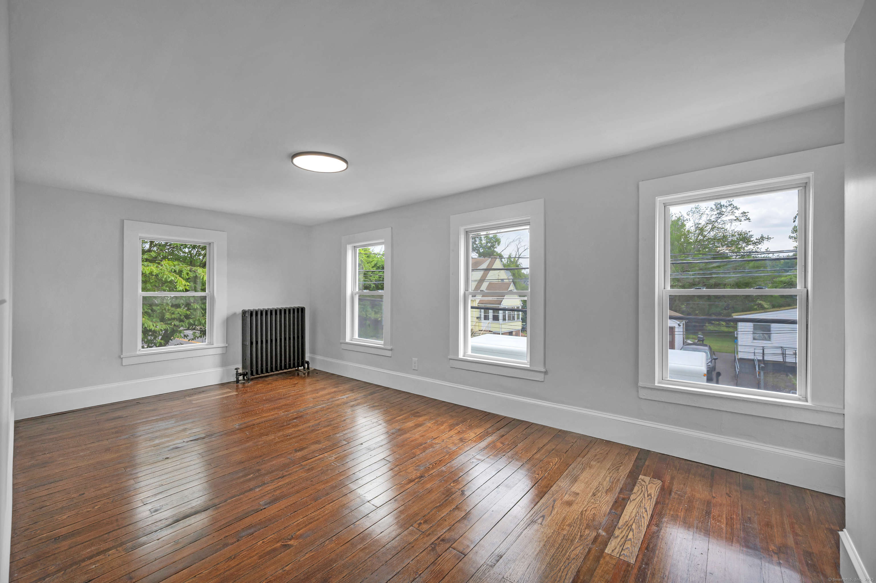 291 Main Street Cromwell, CT 06416 - Photo 30 of 38 a view of an empty room with wooden floor and a window