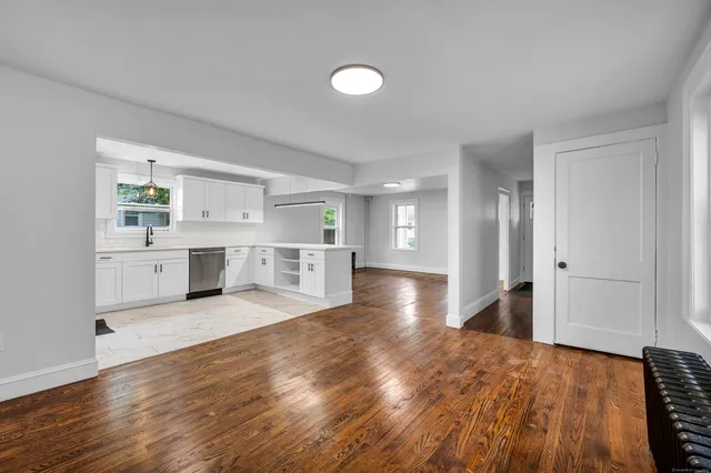 a view of a kitchen with wooden floor and a sink