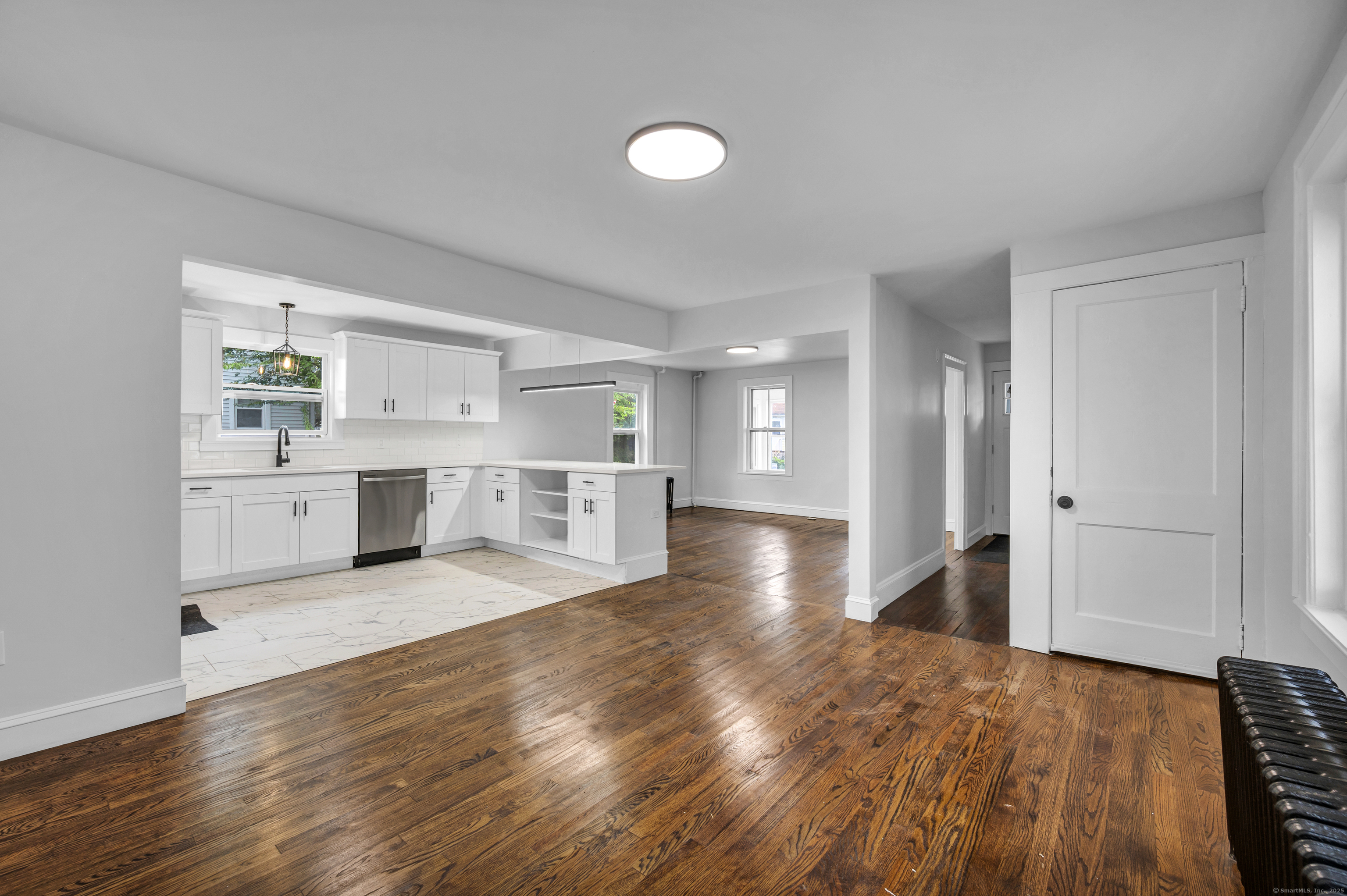 291 Main Street Cromwell, CT 06416 - Photo 3 of 38 a view of a kitchen with wooden floor and a sink