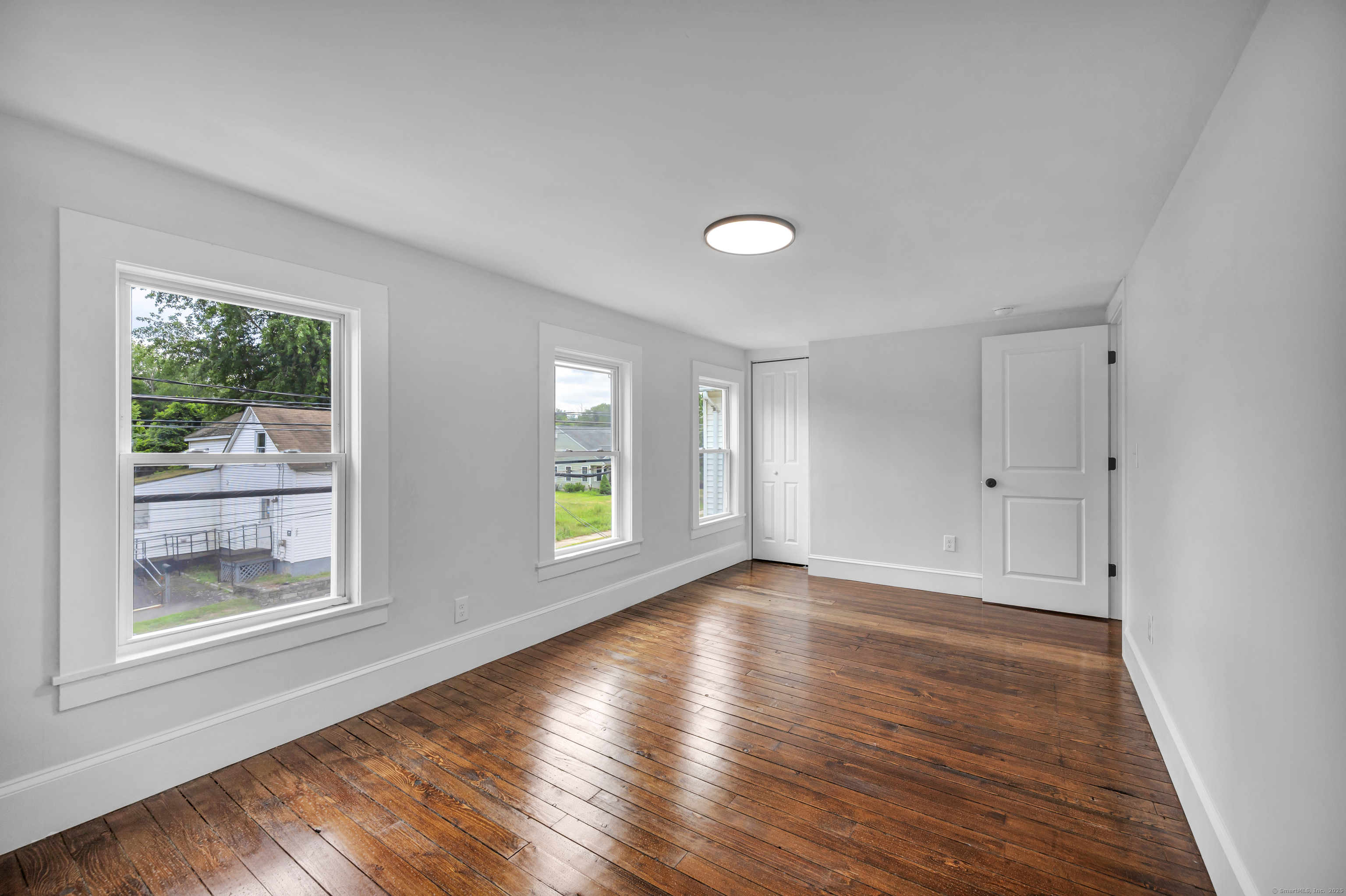 291 Main Street Cromwell, CT 06416 - Photo 31 of 38 a view of an empty room with wooden floor and a window