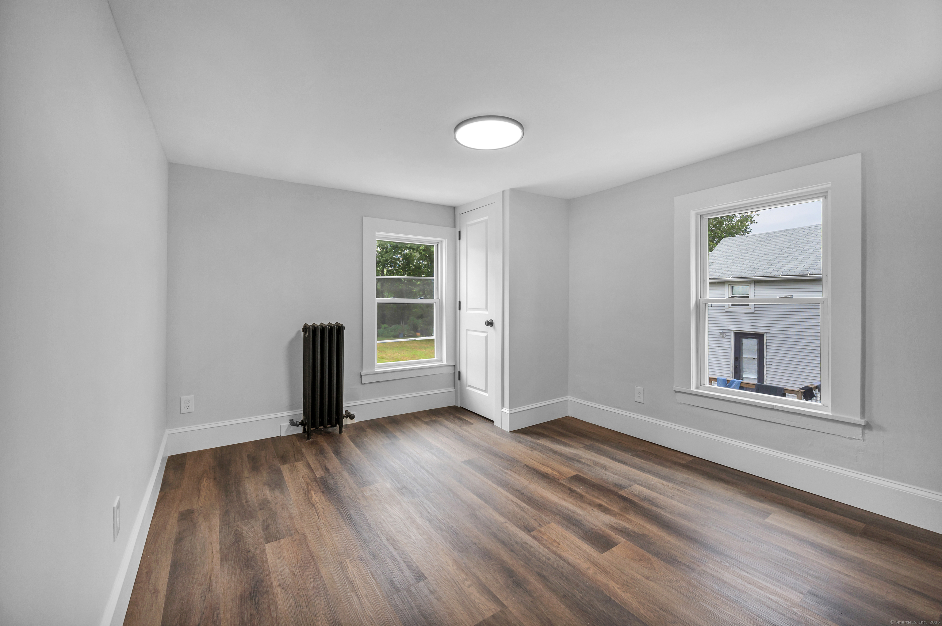 291 Main Street Cromwell, CT 06416 - Photo 32 of 38 an empty room with wooden floor and windows