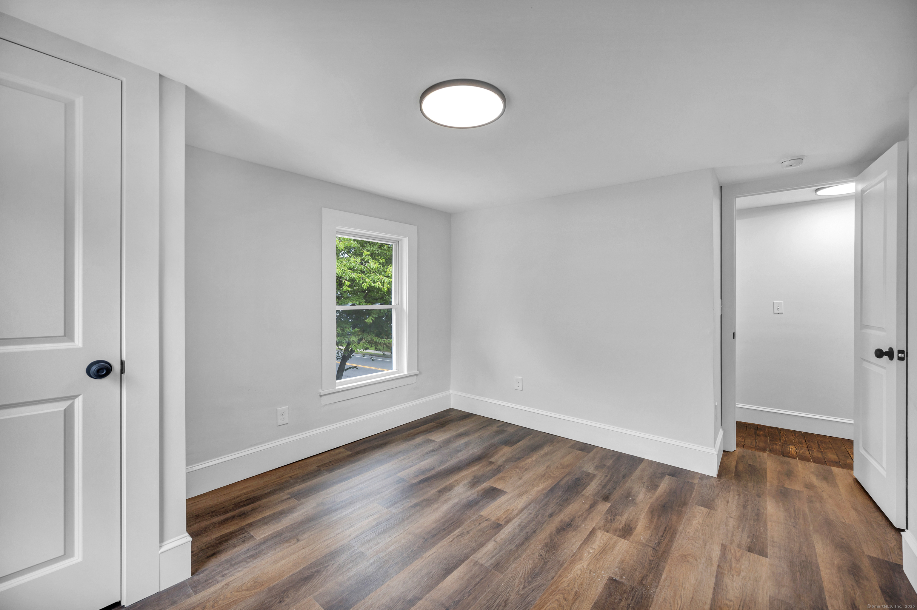 291 Main Street Cromwell, CT 06416 - Photo 33 of 38 a view of empty room with wooden floor and fan