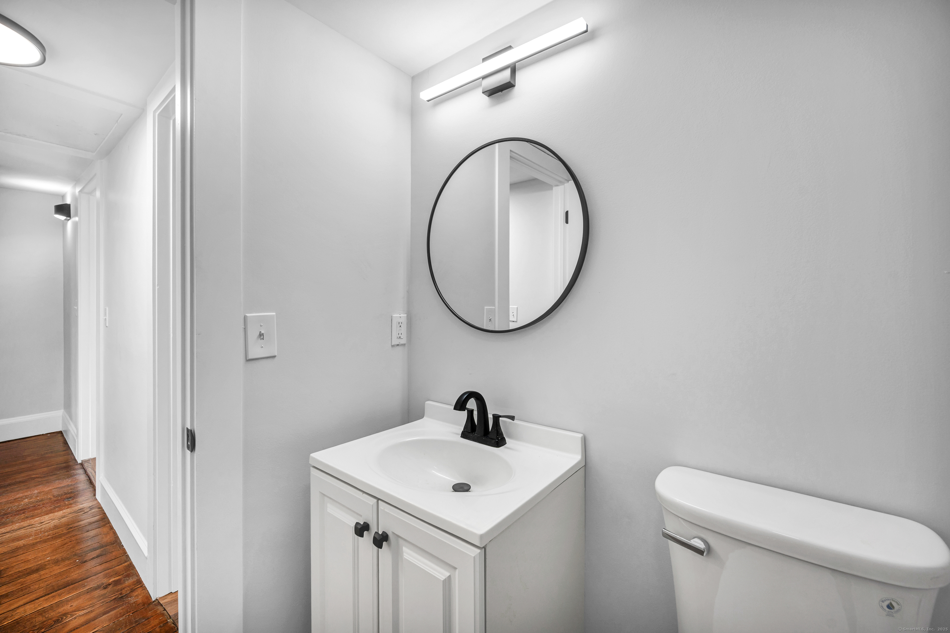 291 Main Street Cromwell, CT 06416 - Photo 36 of 38 a bathroom with a sink a mirror and a toilet