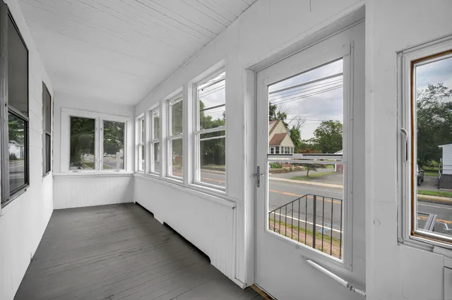 a view of an entryway with wooden floor