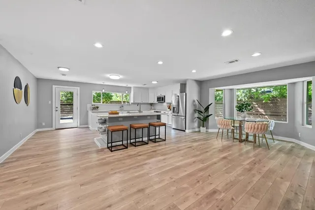 a living room with furniture wooden floor and a table