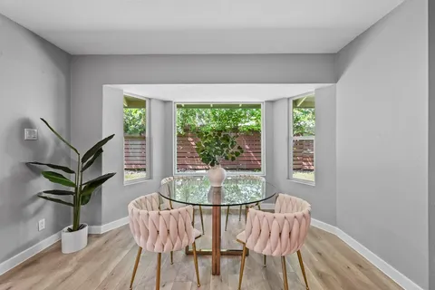 a dining room with furniture and wooden floor
