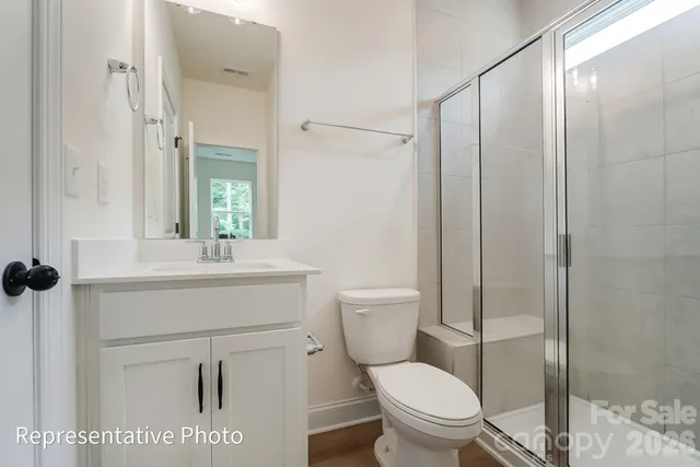 a bathroom with a toilet a sink and a mirror