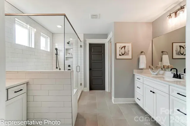 a spacious bathroom with a shower and a sink