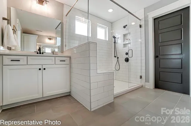 a bathroom with a shower and a sink