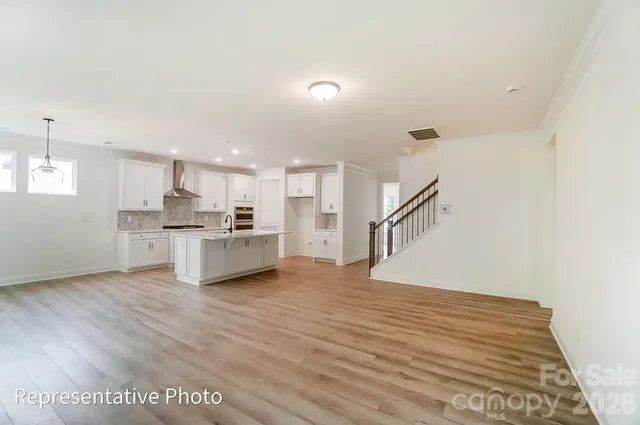 a view of kitchen with wooden floor and electronic appliances