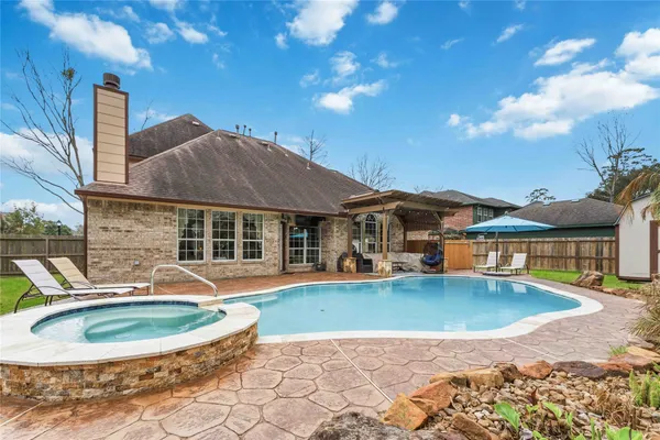 a view of a house with swimming pool and sitting area