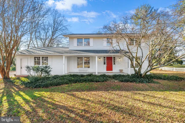 a front view of house with yard and trees around