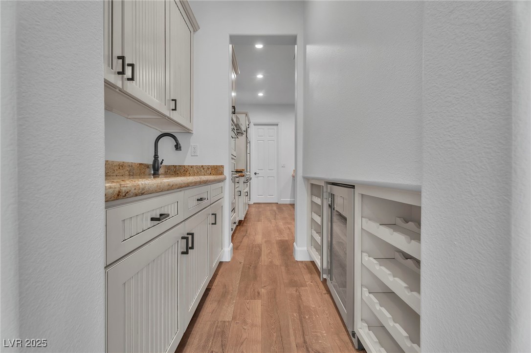 11280 Granite Ridge Drive, Unit 1037 Las Vegas, NV 89135 - Photo 19 of 62 Butlers Pantry with wine refrigerator, wine storage, additional sink