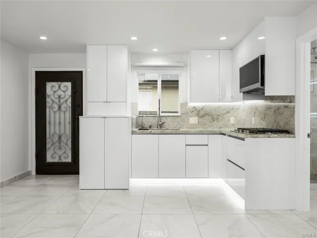 a kitchen with a refrigerator and a sink