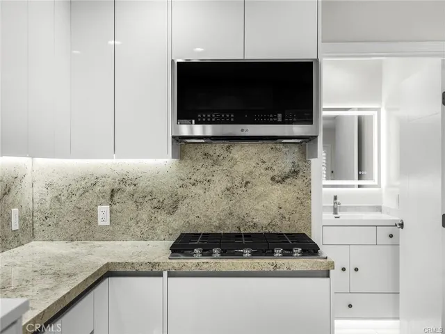 a bathroom with a sink vanity and a toilet