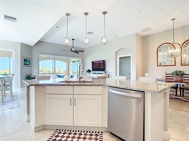 a kitchen with granite countertop a sink and cabinets