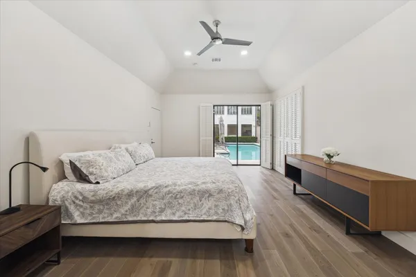 a spacious bedroom with a bed and a window