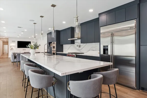 a large kitchen with a table and chairs