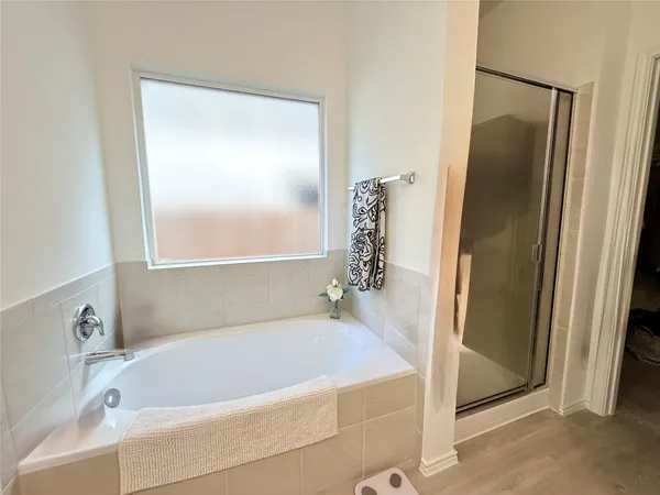 a white bath tub sitting next to a white sink