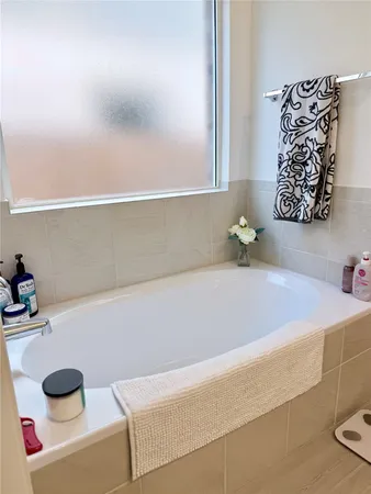 a bedroom with a bed a couch and a window