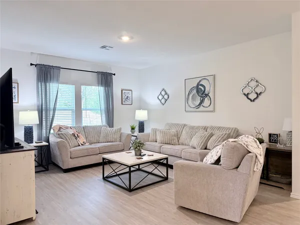a kitchen with stainless steel appliances a sink a stove a table and chairs