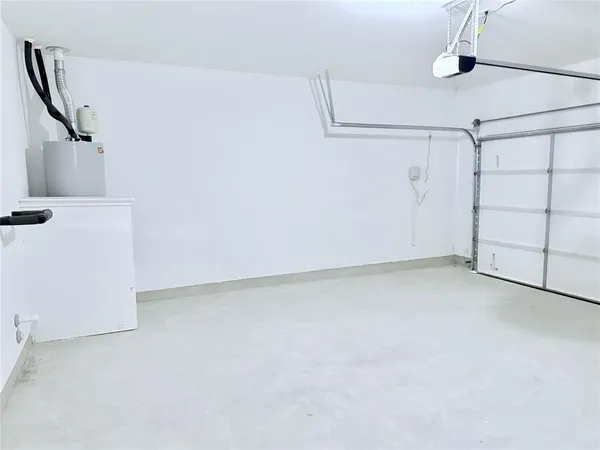 a kitchen with stainless steel appliances a sink a stove a refrigerator cabinets and a dining table