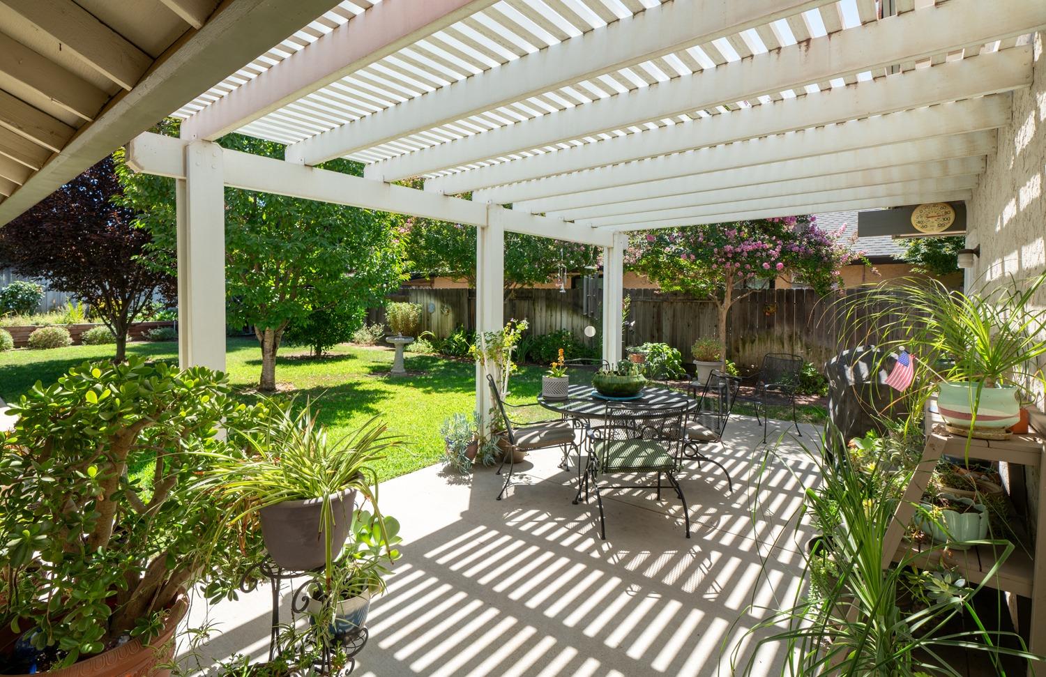 1021 Pistachio Avenue Clovis, CA 93611 - Photo 17 of 27 a view of a porch with chairs and a yard