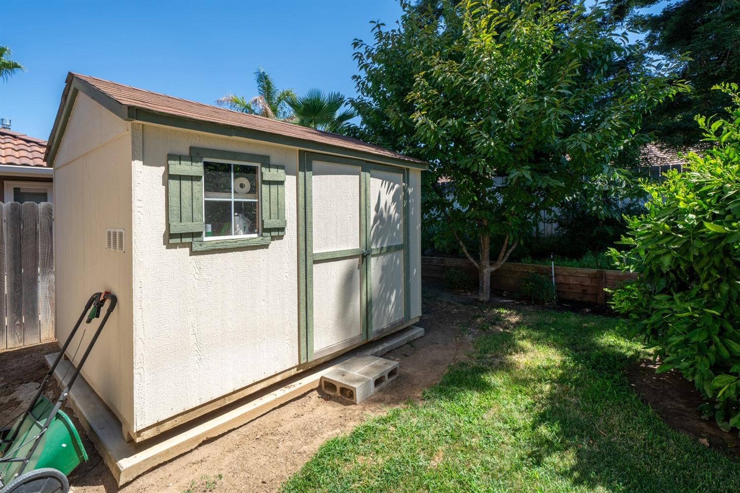 1021 Pistachio Avenue Clovis, CA 93611 - Photo 21 of 27 a view of backyard with large trees and wooden fence