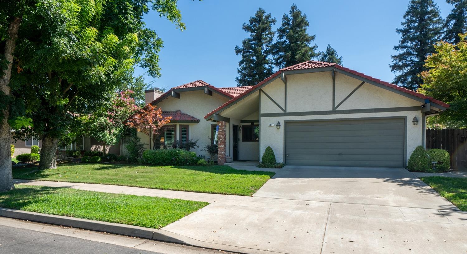 1021 Pistachio Avenue Clovis, CA 93611 - Photo 24 of 27 a front view of a house with a yard and garage