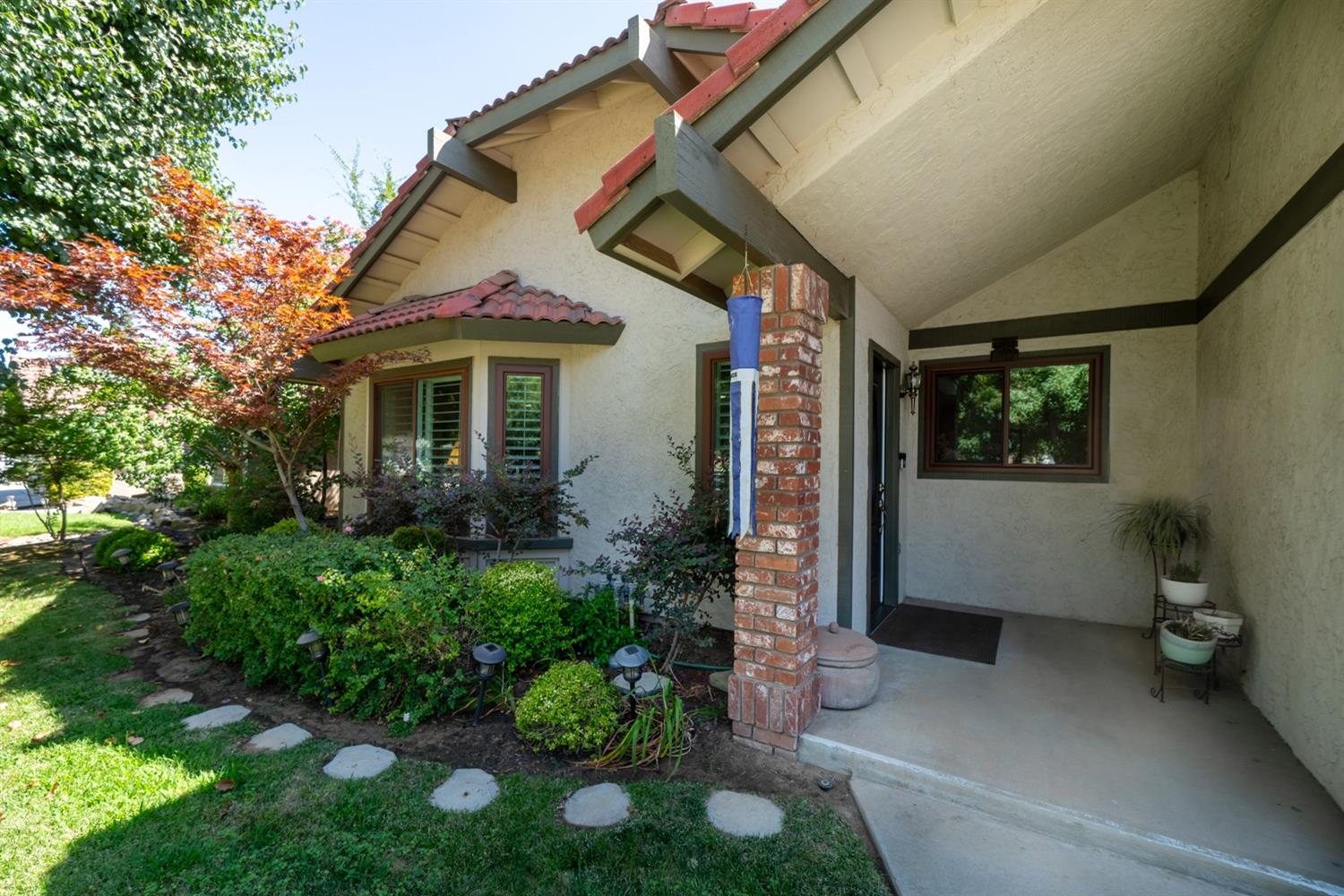 1021 Pistachio Avenue Clovis, CA 93611 - Photo 5 of 27 a view of a house with a small yard and potted plants