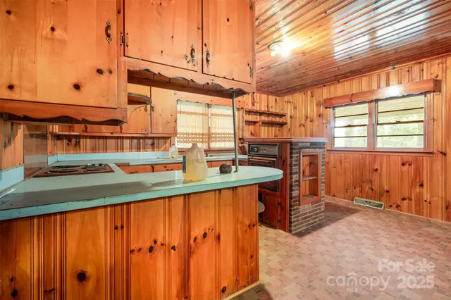 a kitchen with granite countertop white cabinets white stainless steel appliances with a sink and dishwasher