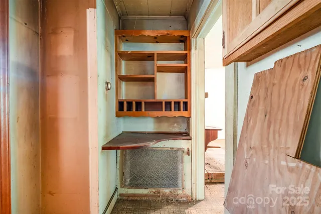 a backyard of a house with wooden floor and a large tree