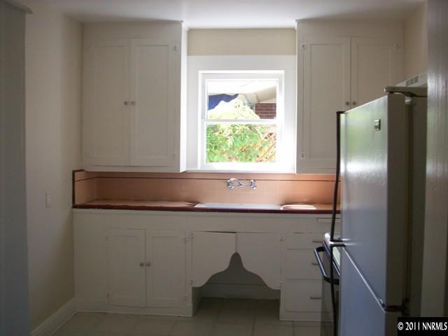 790 Roberts Street Reno, NV 89502 - Photo 4 of 9 a kitchen with a sink a refrigerator and window